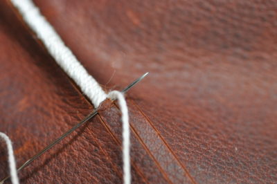 needle going through leather thickness