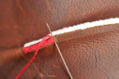needle going through leather