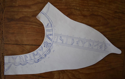 paper with runic characters and decorative elements drawn on it