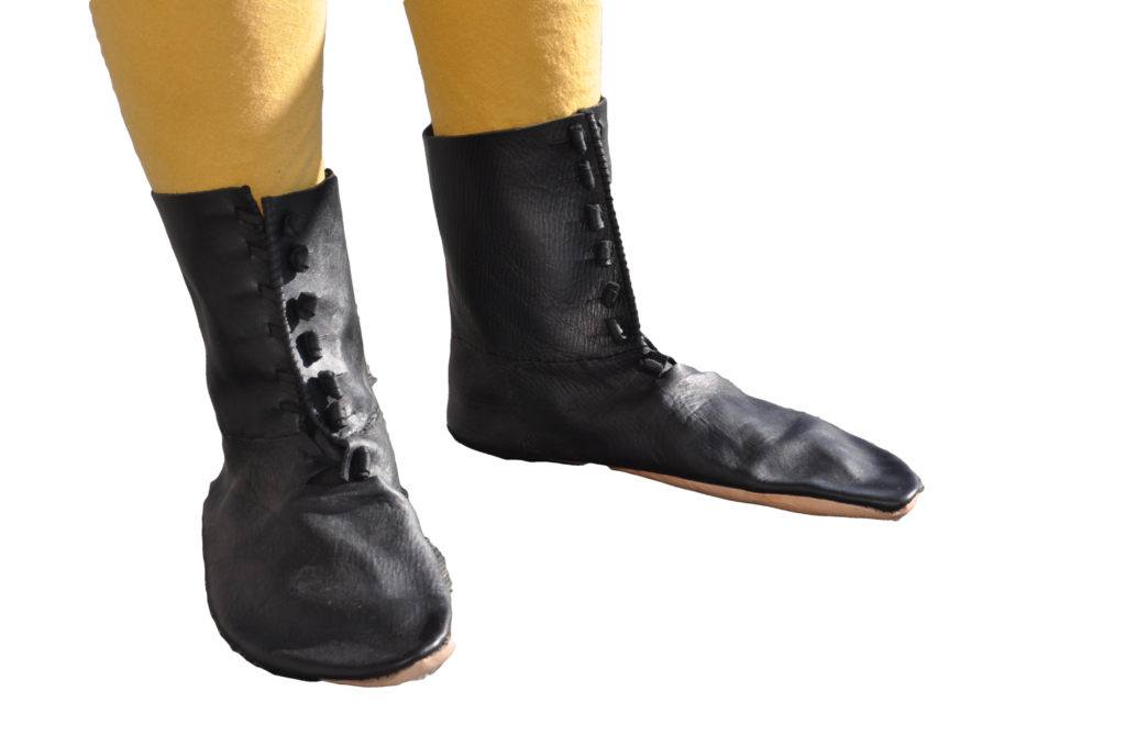 a pair of black boots with 6 leather toggles for securing them
