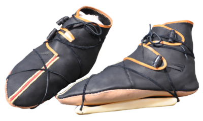 pair of leather shoes strapped to bone ice skates